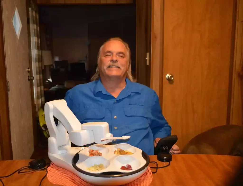 Photo is of an Obi user, Alan, who is a veteran, using Obi at home